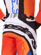 Alpinestars 2025 Techstar Melt Pants, Motocross Pants, Orange and Blue, close-up rear view of the seat and waistband, bold black branding on white background, orange panels with red star logos, athletic performance gear for off-road racing
