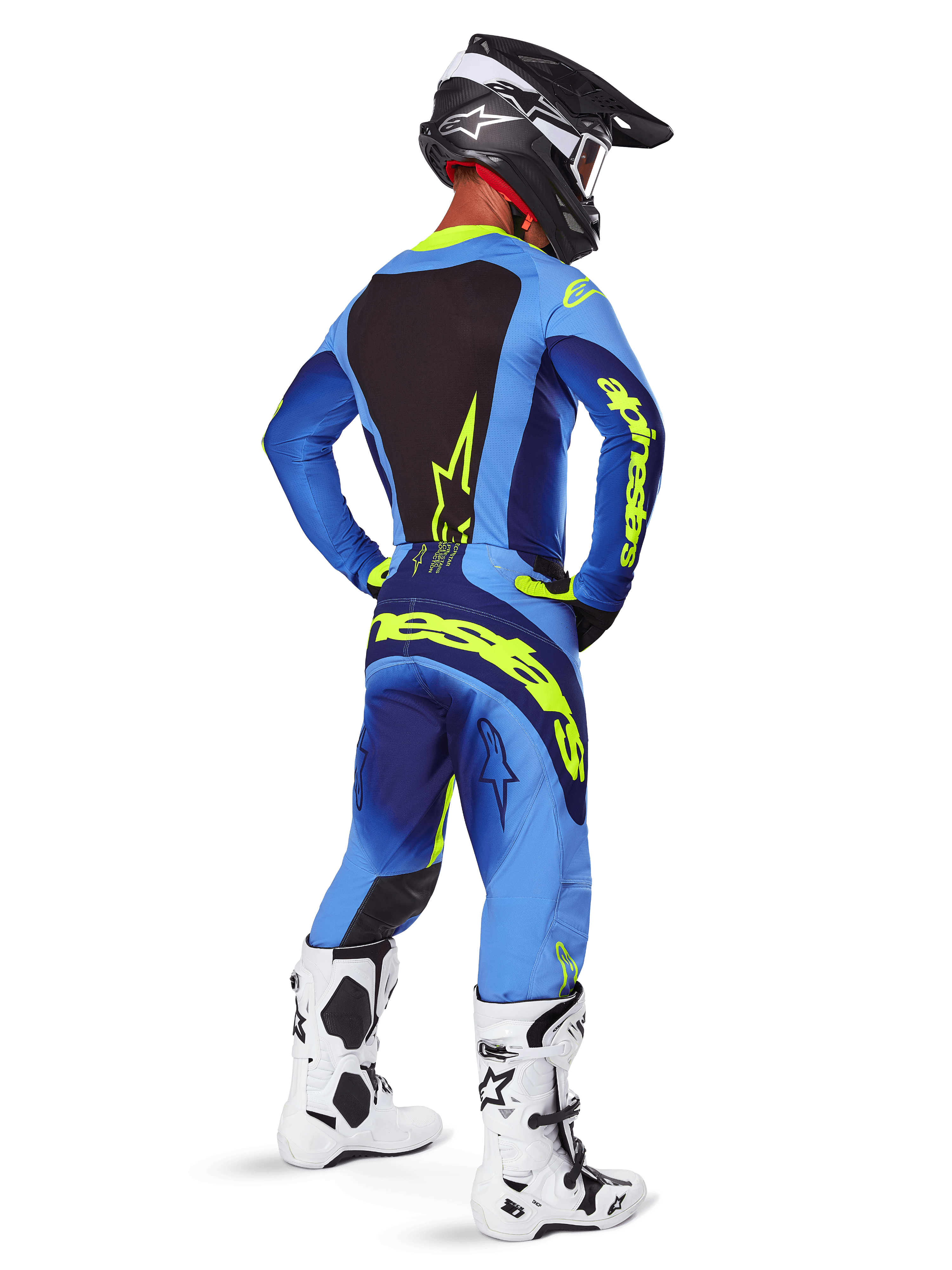 Alpinestars 2025 Techstar Melt Pants, Motocross Gear, Yellow Fluo Blue, rear view of rider wearing matching blue jersey with large yellow branding, white and black boots, and black helmet, coordinated racing outfit for off-road performance
