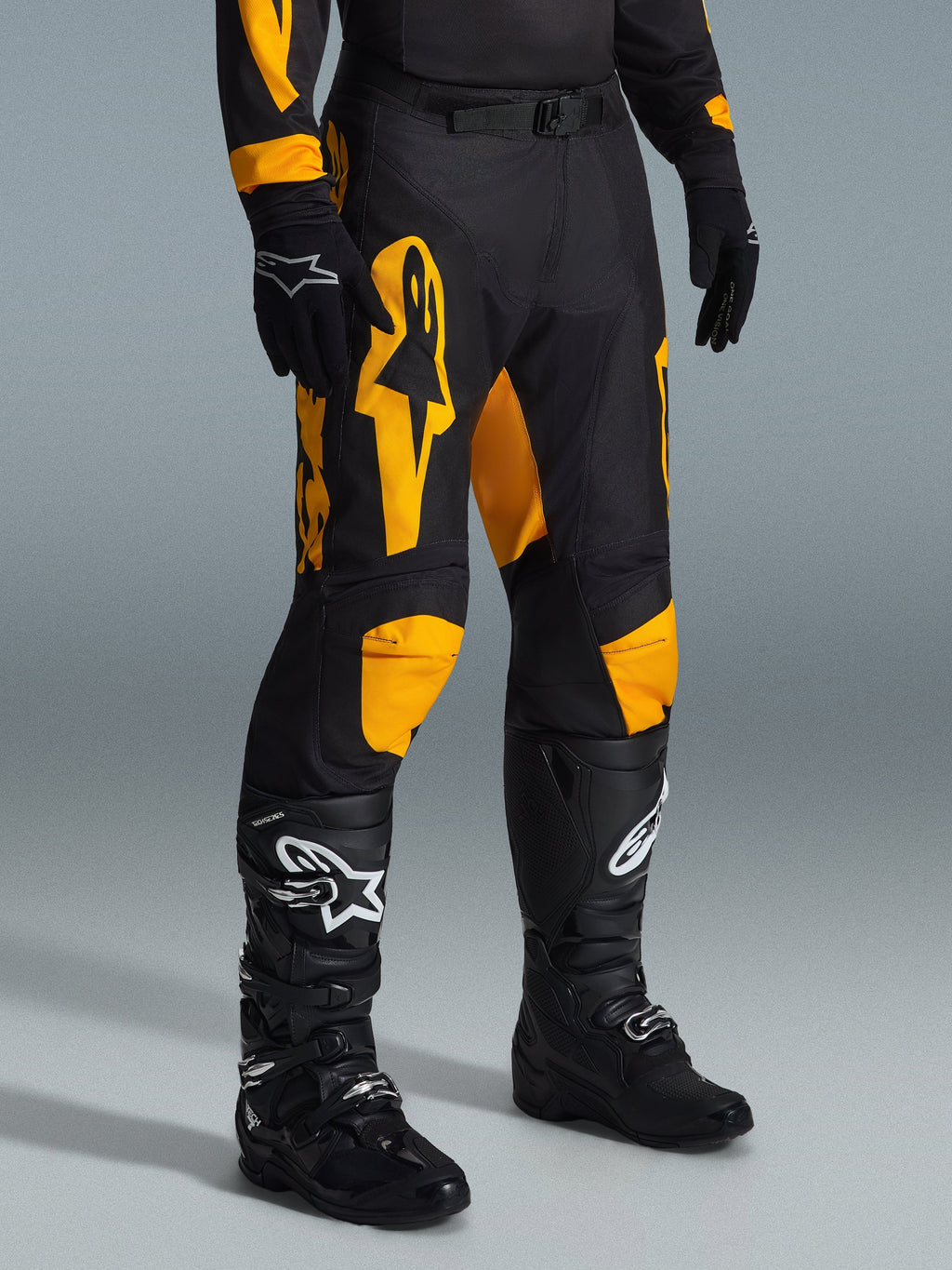 Alpinestars 2026 Racer Riway bukser, motocross-bukser, gul og sort, båret med sorte handsker og sorte motocross-støvler, med markant gul Alpinestars-branding og knædetaljer på en sort base, designet til højtydende off-road kørsel
