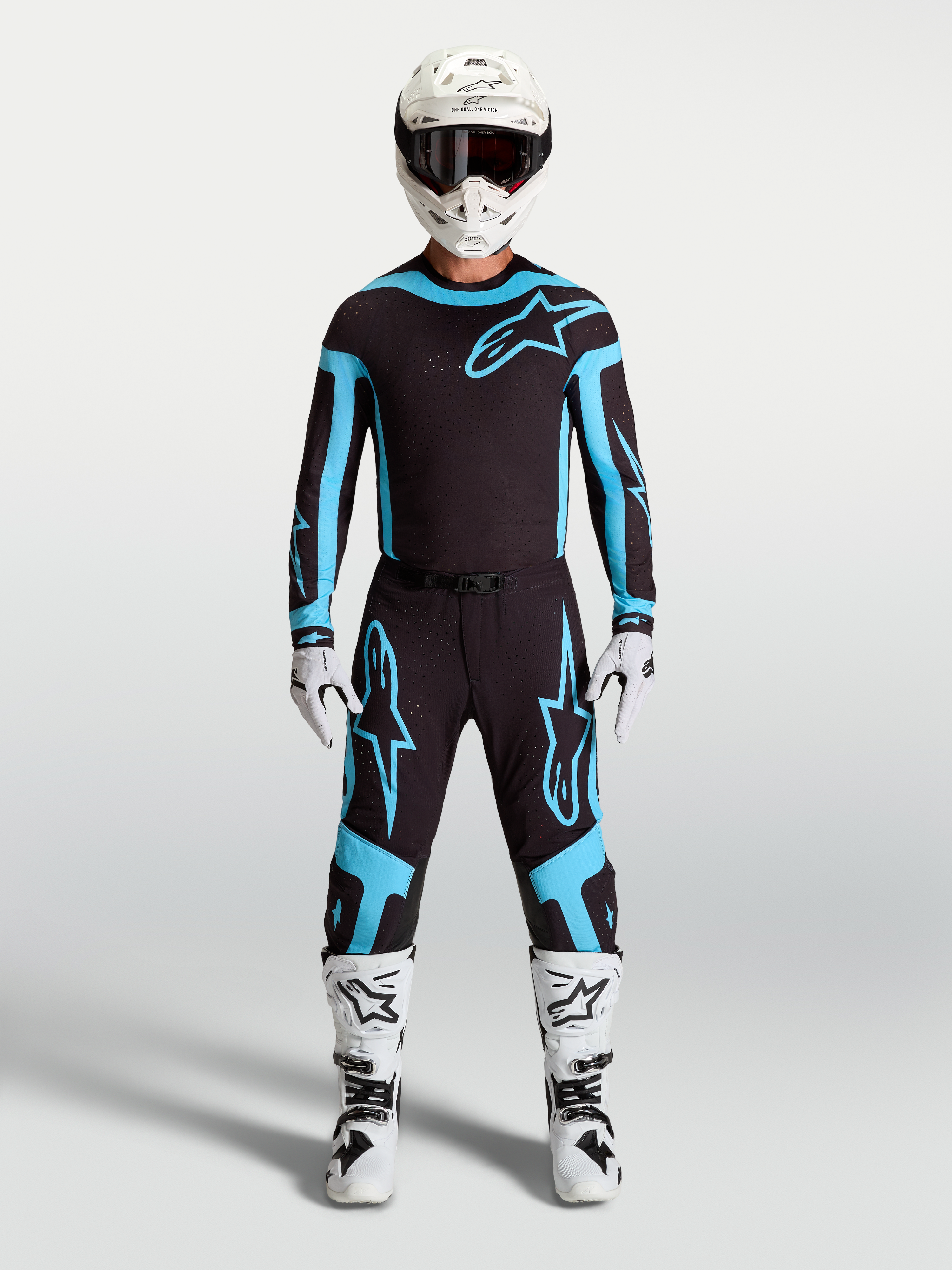 Alpinestars Supertech Vesta Pants, men's motocross racing gear in black and turquoise, featuring lightweight stretch construction on model.