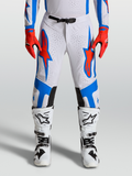 Alpinestars Supertech Vesta Bukser, hvid, rød og blå, professionelle motocrossbukser til herre med atletisk race-pasform og perforeringer.