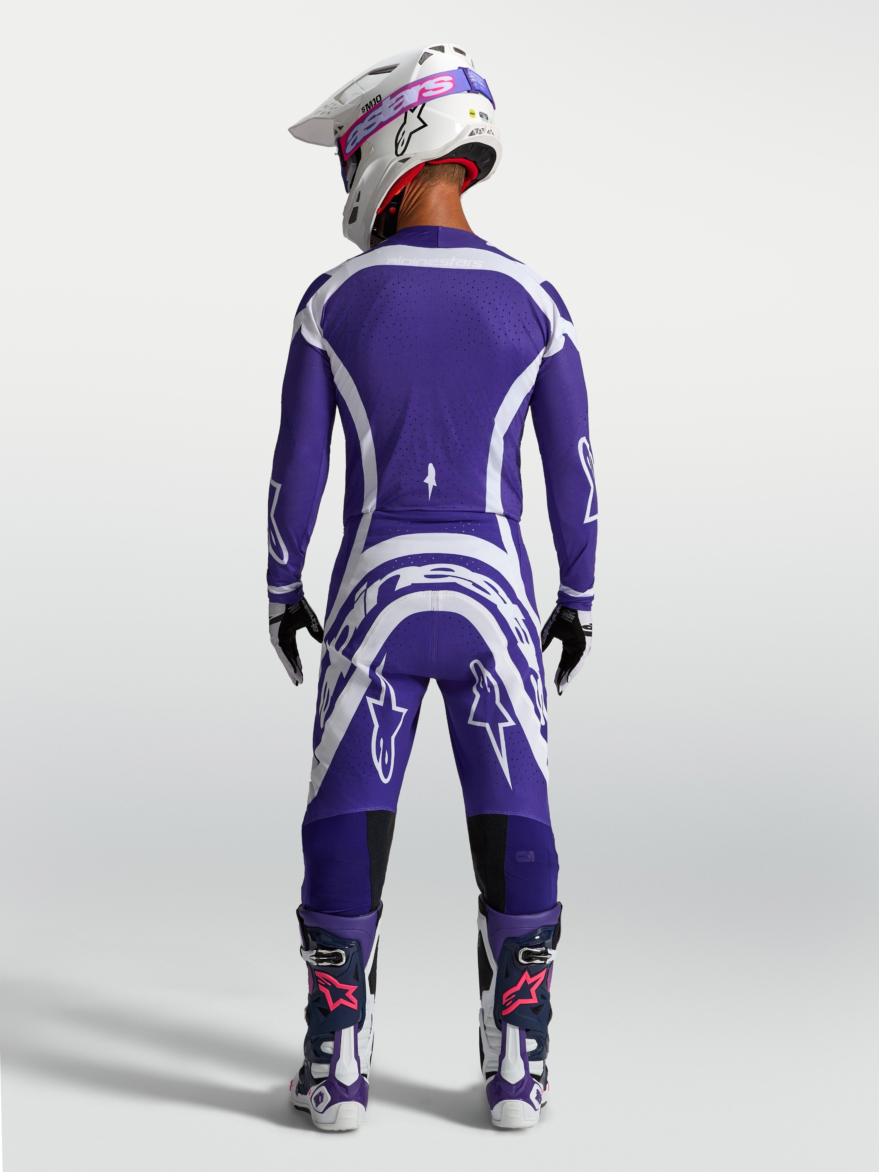 Alpinestars Supertech Vesta Pants and Jersey, Deep Blue and White motocross racing gear set shown from a rear view on model.