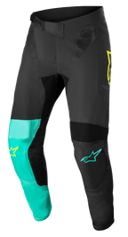 Alpinestars Supertech Blaze bukser, motocross-bukser, sort, pastelgrøn og gul fluo, med asymmetriske benpaneler, gule og turkise stjernelogoer, mesh-ventilationsindsatser og justerbart taljebælte til off-road racing