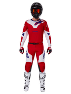 Alpinestars 2025 Racer Veil Pants and complete motocross gear set, Bright Red and White with blue accents, featuring a matching jersey, black helmet with orange goggles, white and black boots, and red gloves, coordinated performance look for off-road racing