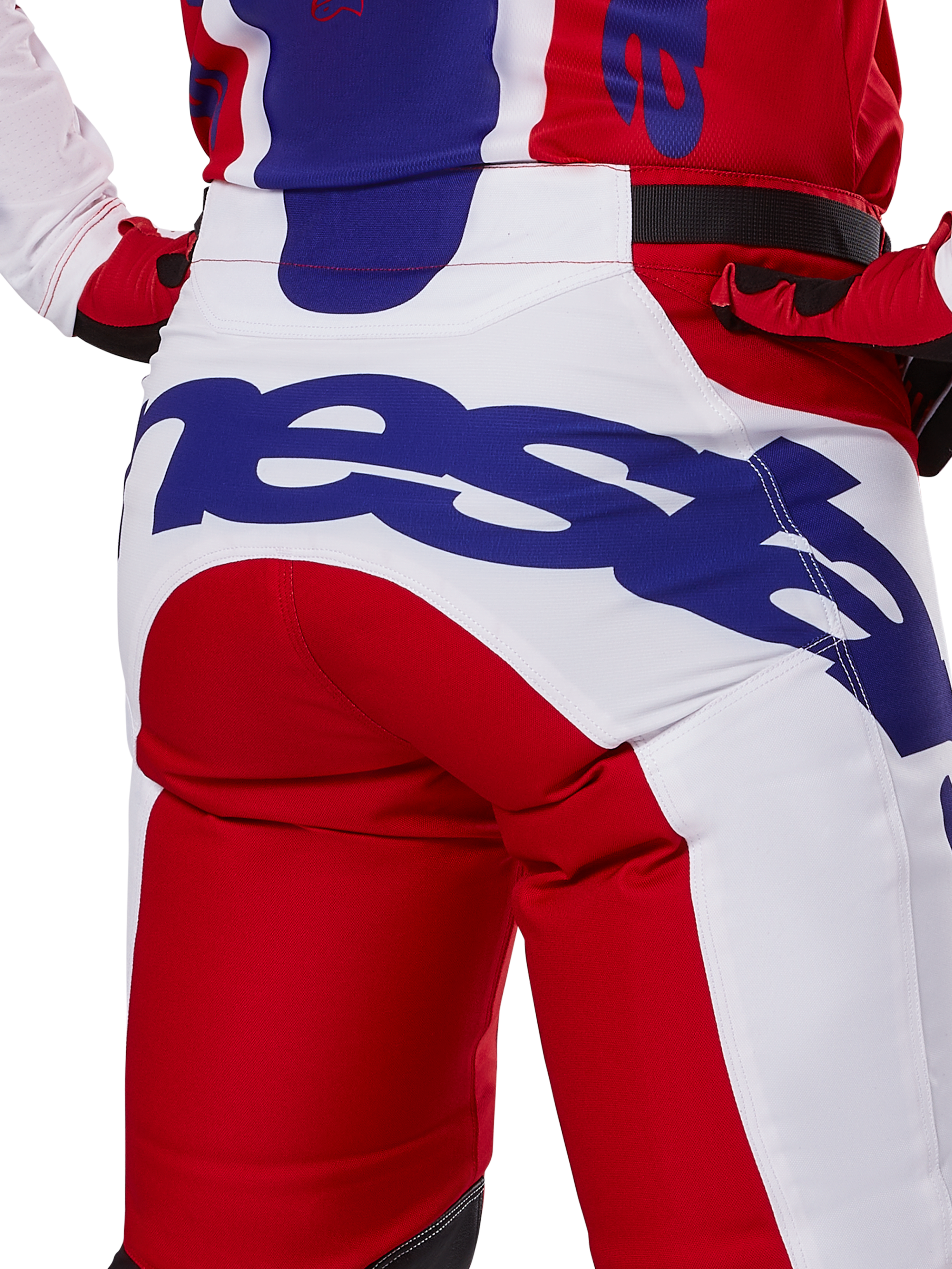 Alpinestars 2025 Racer Veil Pants, Motocross Pants, Bright Red and White with blue branding, back view detail of seat area featuring a large Alpinestars logo, worn as part of a coordinated off-road racing outfit
