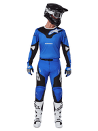 Alpinestars 2025 Racer Veil Pants, Motocross Pants, Blue and Black, worn as a complete racing outfit with a matching blue and black jersey, black and white helmet, blue gloves, and white boots, featuring bold logos and an ergonomic design for off-road riding.