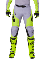 Alpinestars 2025 Racer Veil Pants, Motocross Pants, Gray and Yellow Fluo, worn with matching fluorescent yellow boots and gloves, featuring black Alpinestars logos, ergonomic design for off-road racing