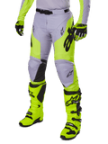 Alpinestars 2025 Racer Veil Pants, Motocross Pants, Gray and Neon Yellow Fluo, featuring black star logos and adjustable waist belt, shown with matching motocross boots and gloves, ergonomic design for off-road riding