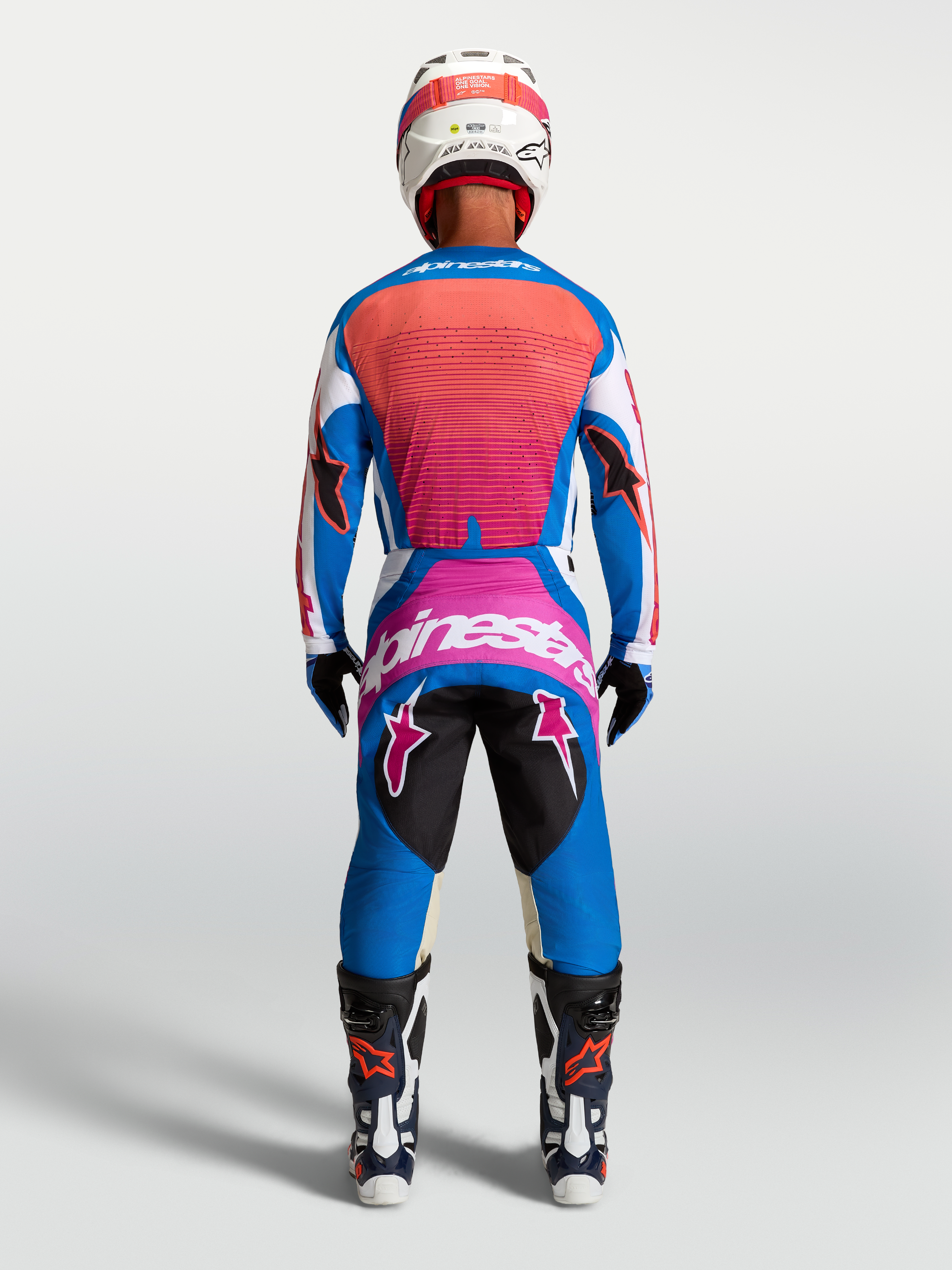 Alpinestars Techstar Maven Pants, Men's Motocross Racing, Blue and Hot Coral, athletic fit rear view in full racing gear.