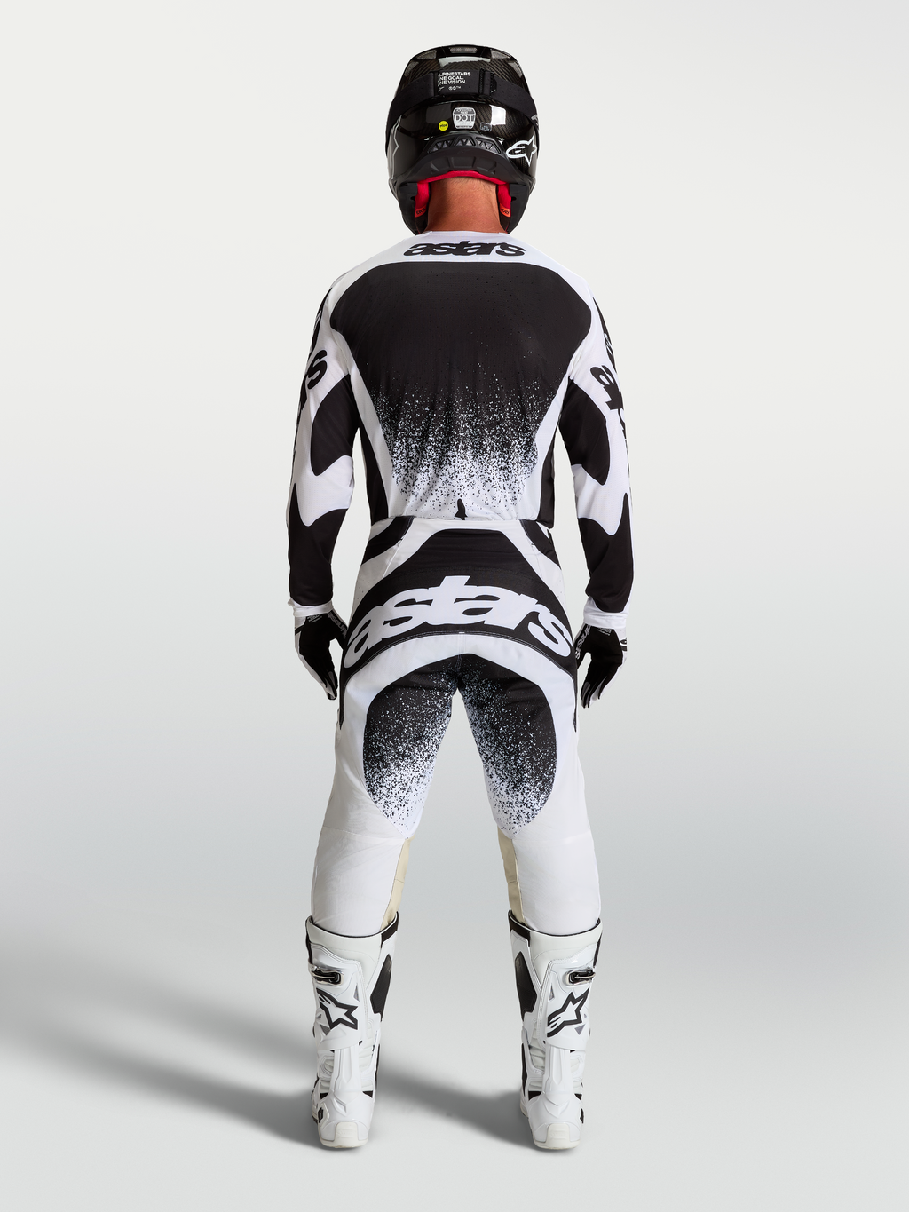 Alpinestars Techstar Swan herre-motocross-sæt med trøje og bukser i sort og hvid, atletisk race-pasform og branding bagpå.