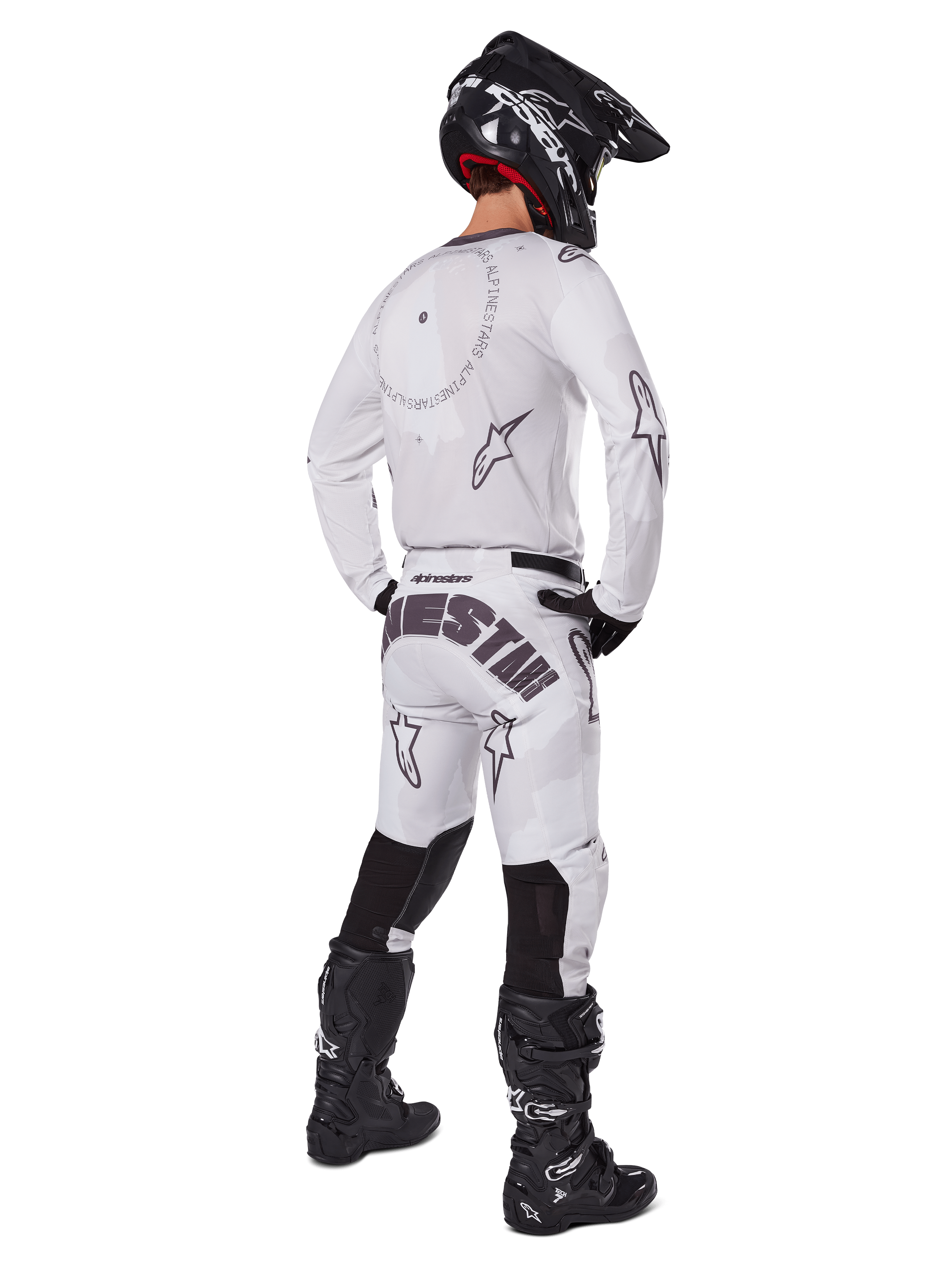 Alpinestars 2025 Racer Hollow Pants, Motocross Pants, Light Camo Brown and White, rear view showing bold black branding on the seat and star logos, worn with matching jersey, black boots, and black helmet for a complete off-road racing look
