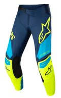 Alpinestars Techstar Factory bukser, motocross racingbukser, mørkeblå, neongul og lyseblå, med sorte indvendige knæpaneler, gult stjernelogo på låret, "ONE GOAL ONE VISION" branding og perforerede ventilationszoner til off-road udstyr