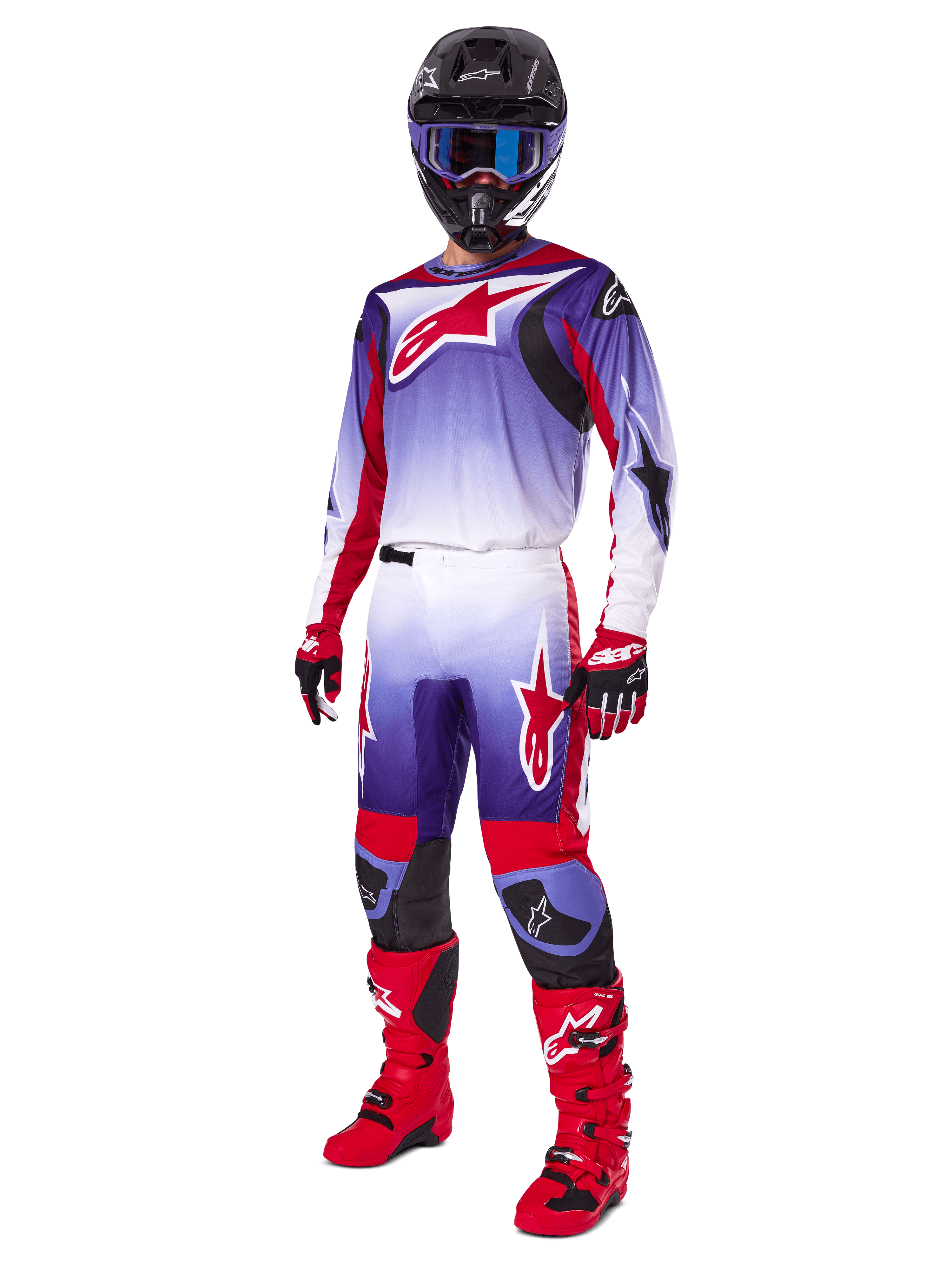 Motocross rider wearing complete racing gear, 2025 Fluid Wurx Pants and matching jersey in Purple Bright Red and White, large red Alpinestars logo, red boots and gloves, black helmet with blue goggles, coordinated outfit for off-road racing
