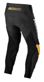 Alpinestars Techstar Quadro bukser, motocross-bukser, sort, gul og tangerine, set bagfra med gult 'ASTARS' branding på linningen, sorte mesh-indsatser for ventilation og ergonomiske gule og tangerine knæpaneler for off-road holdbarhed.
