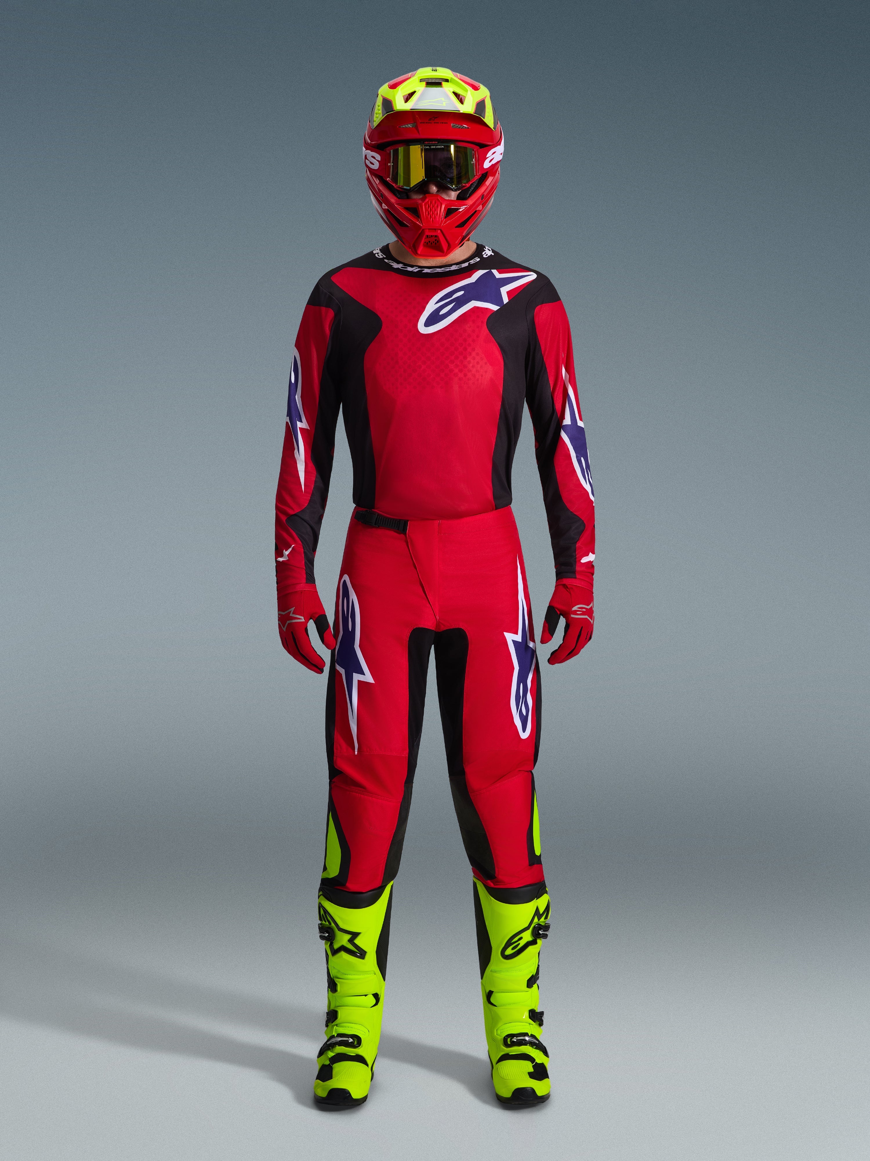 Alpinestars 2026 Fluid Grid Gear Set, Motocross Outfit, Red and Black, complete riding gear with red jersey and pants featuring blue and white logos, matching red helmet with neon yellow accents, and neon yellow boots, high-performance design for off-road racing