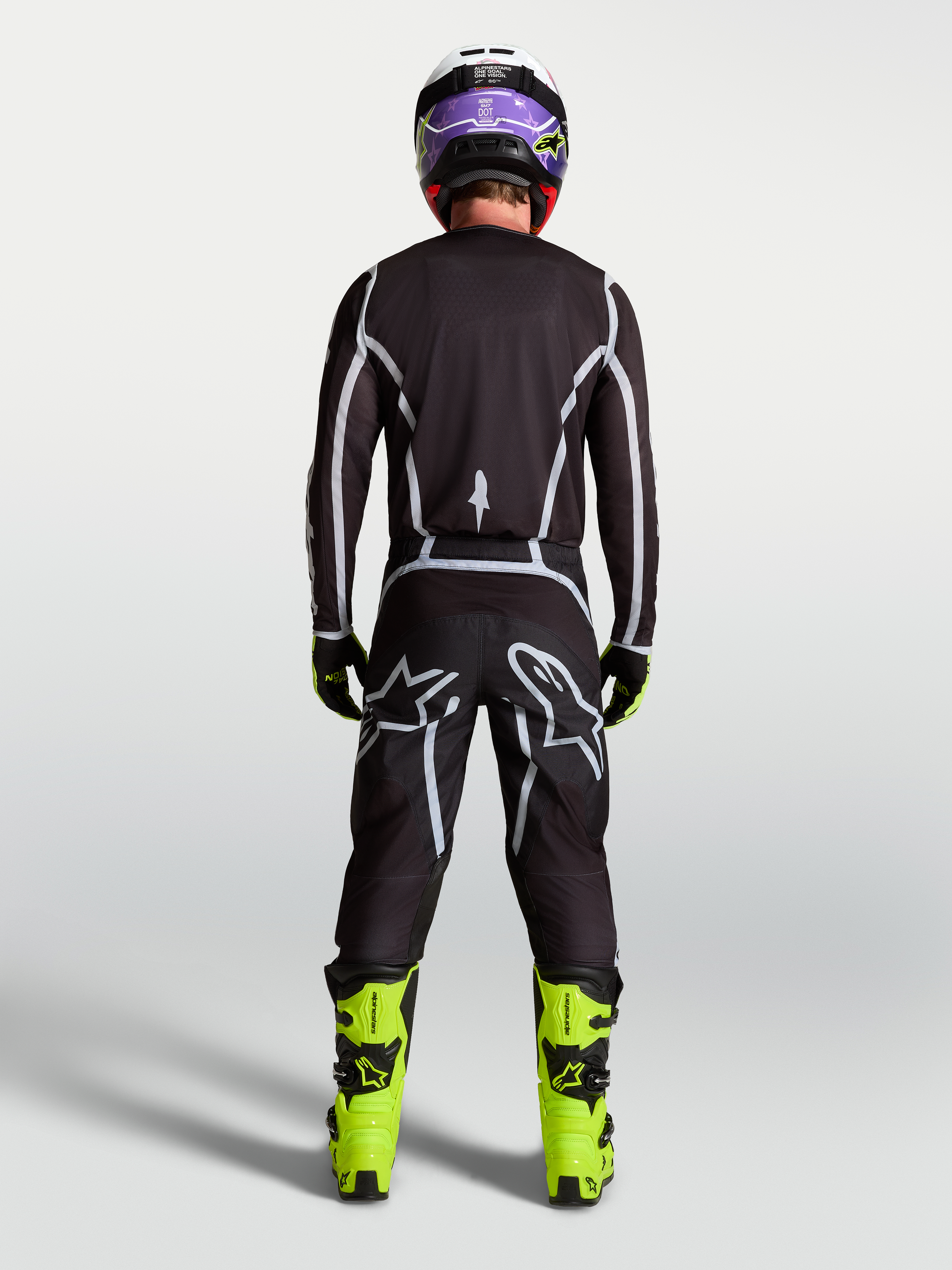 Alpinestars Fluid Apex V2 Pants, Men's Motocross Pants, Black and Silver, rear view on rider with ergonomic sport fit.