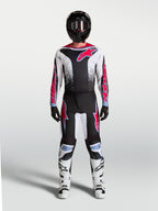 Alpinestars 2027 Fluid Drag Pants, black and white motocross gear with red and light blue accents, shown as a full gear set.
