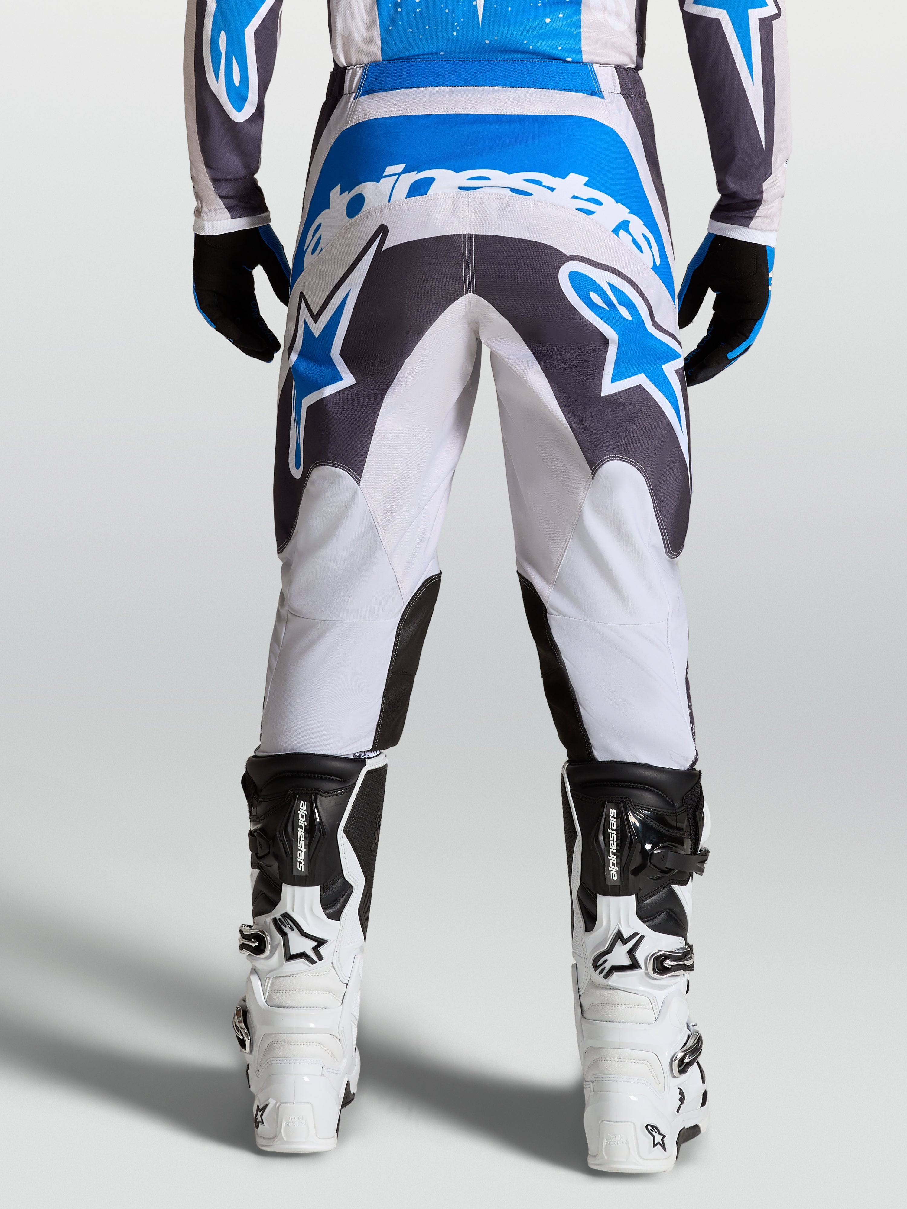 Alpinestars Fluid Drag Pants, men's motocross gear in graystone and blue, featuring a reinforced seat for off-road riding.