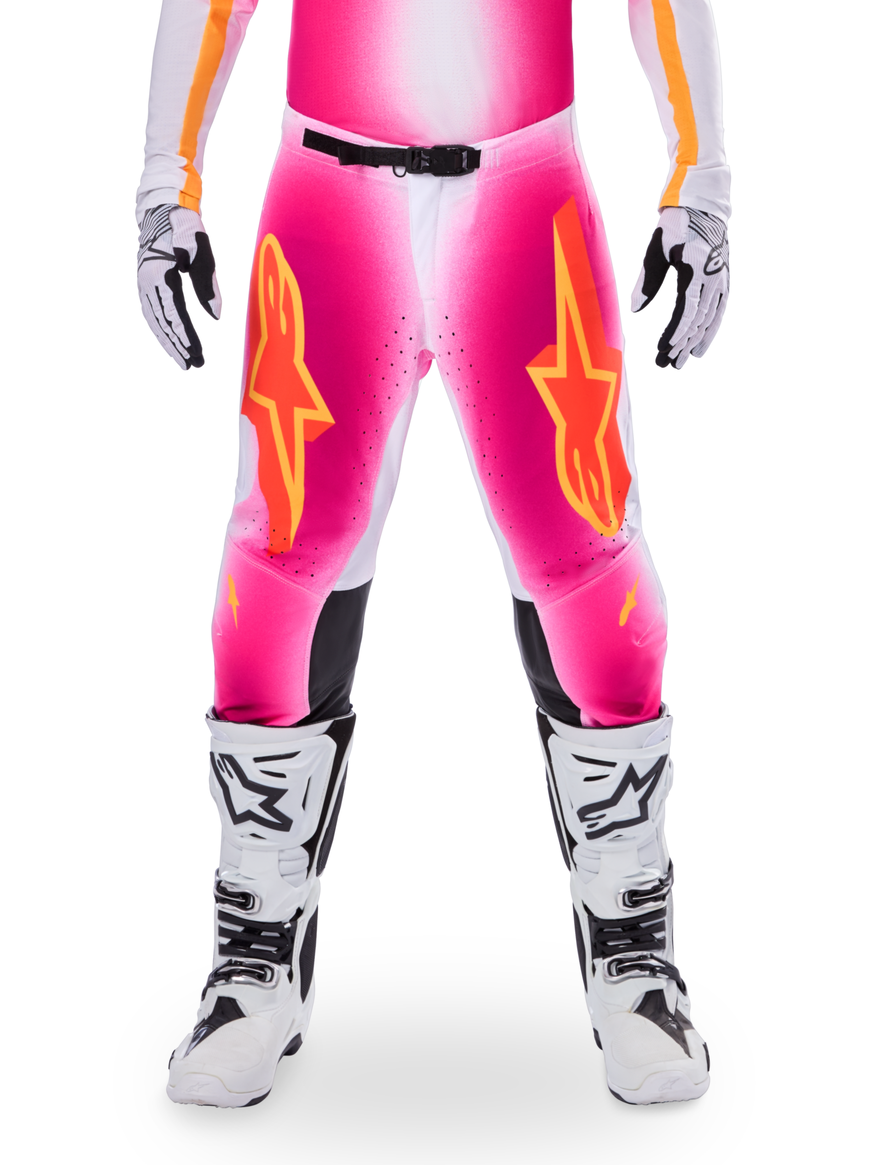 Alpinestars Limited Edition Supertech AFD MIG Pants, Motocross Racing Pants, Pink Fluo and White with Orange accents, featuring large star logos on the thighs, perforated panels, and black knee grip zones, worn with white and black motocross boots