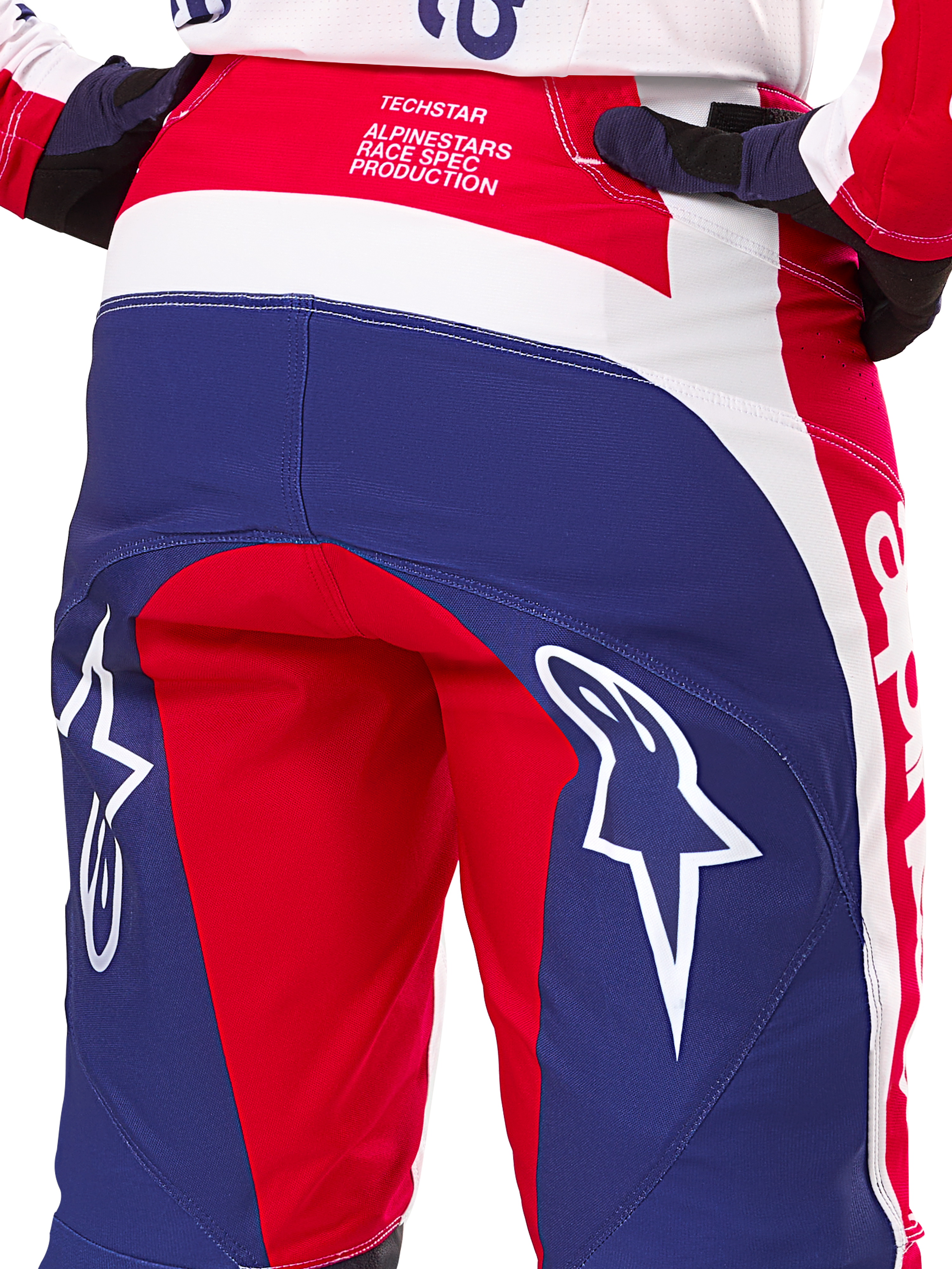 Alpinestars Limited Edition Techstar Fortitude bukser, motocrossbukser, rød, hvid og blå, set bagfra med store hvide stjernelogoer på bagdelen og Techstar Race Spec-branding, slidstærke performance-tekstiler til off-road racing
