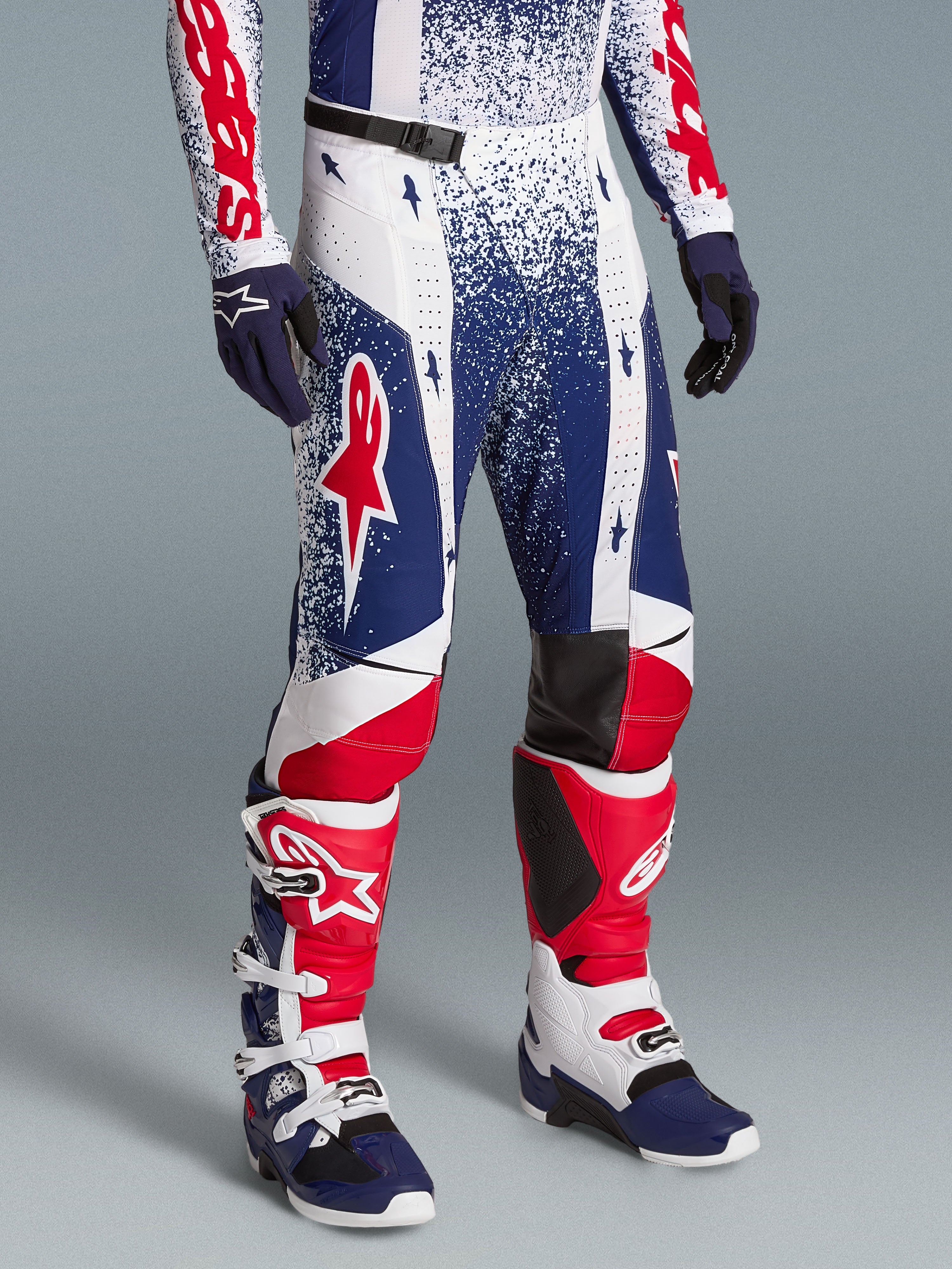 Alpinestars Limited Edition Techstar Unity Motocross Pants in red, white, and blue, featuring an ergonomic race fit.