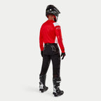 Alpinestars Techdura Pants, Enduro Off-Road Pants, Black, rear view worn by a rider with a red and white jersey and black and white boots, featuring white star logos on the back and durable technical stretch construction.