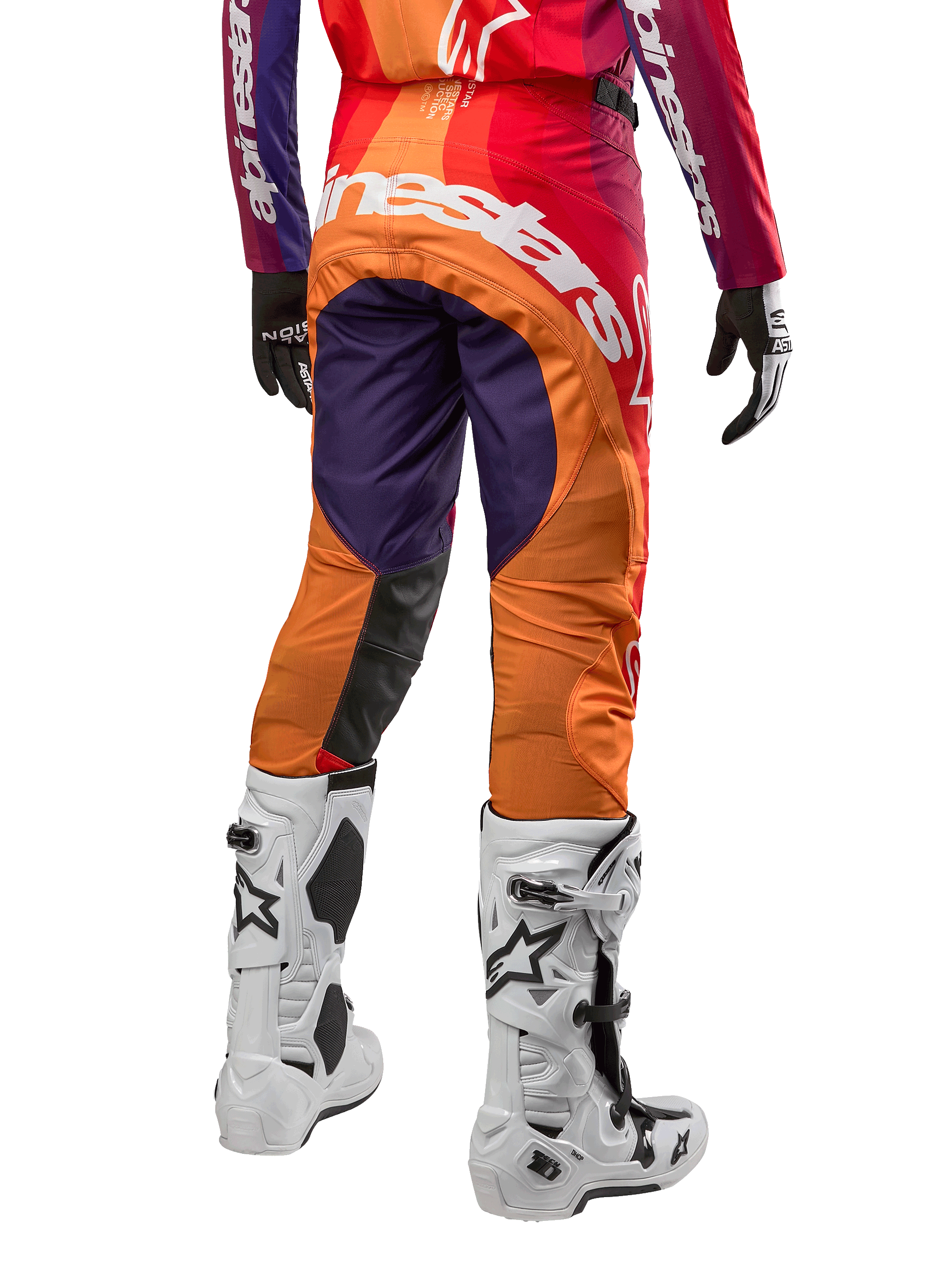 Alpinestars 2024 Techstar Pneuma bukser, motocross terrænbukser, mørkelilla, orange og mørkeblå, stort hvidt logo på bagsiden, vist bagfra med hvide støvler og sorte handsker, professionelt racingudstyr til off-road kørsel