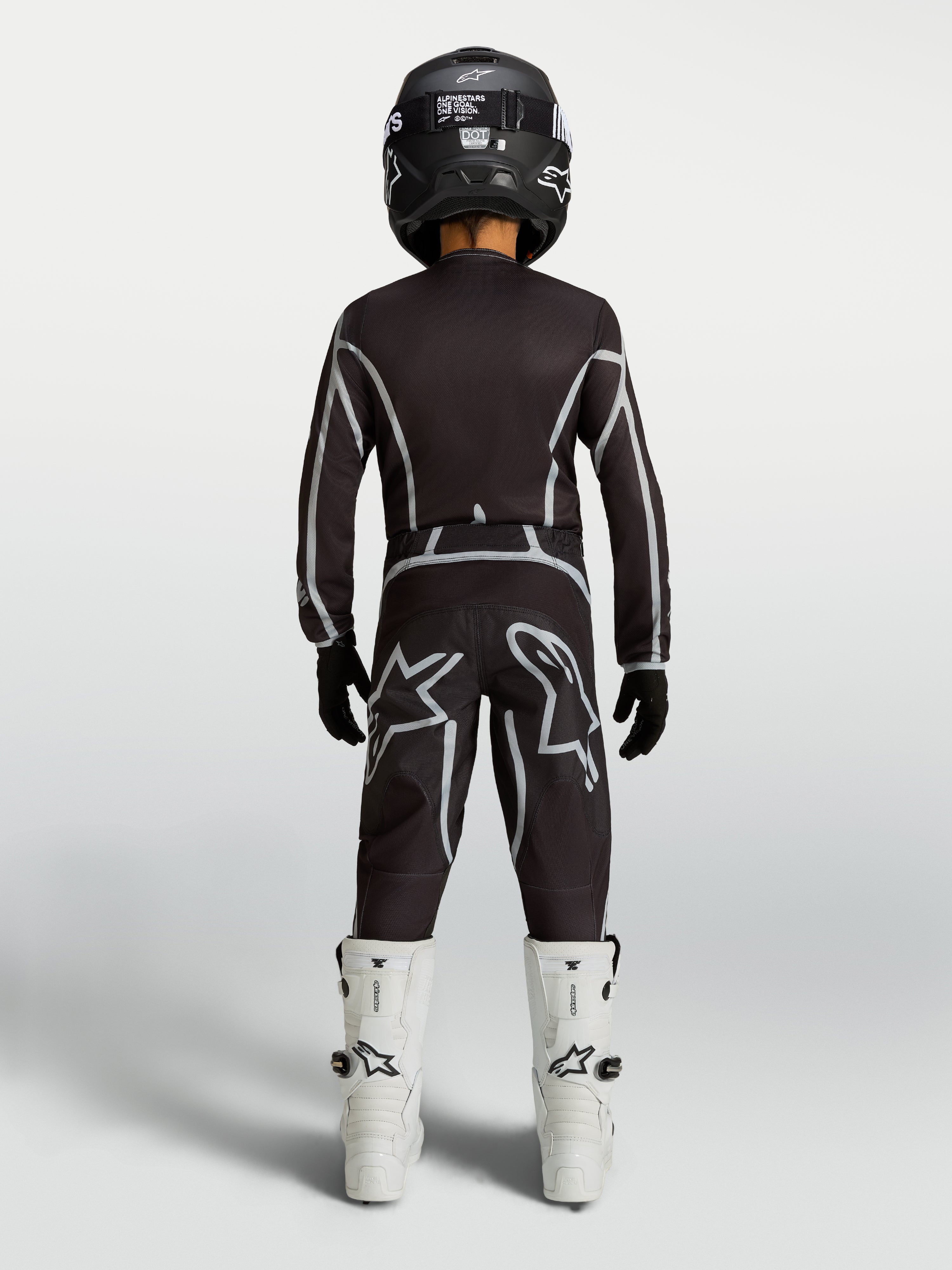 Alpinestars Youth Fluid Apex V2 Pants, black and silver youth MX pants with ergonomic riding fit, shown from the rear.