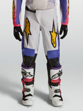 Alpinestars 2027 Fluid Drag bukser til ungdom, hvide og blå motocrossbukser med guldgrafik og ergonomisk pasform.