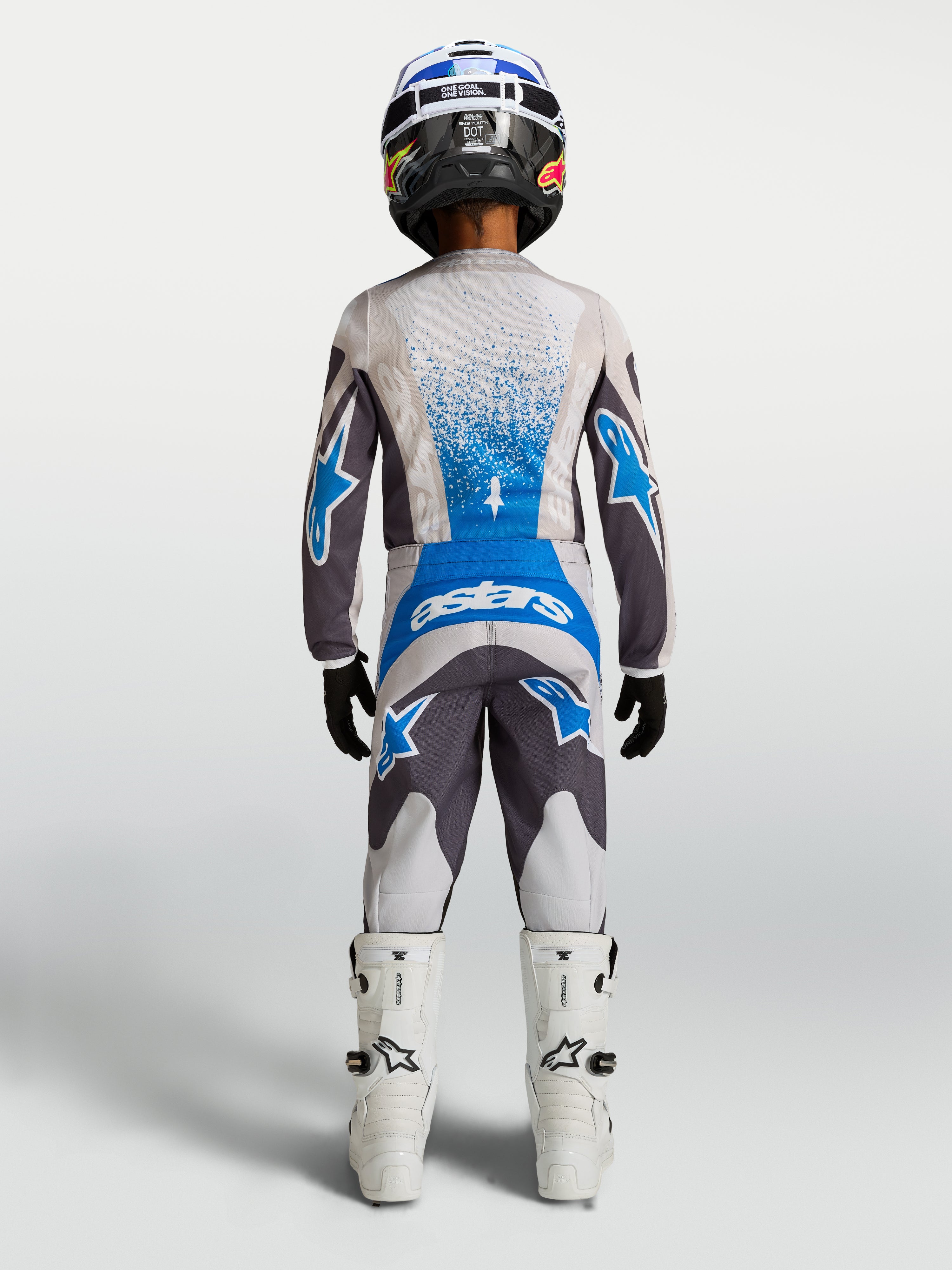 Alpinestars Youth Fluid Drag Pants, Motocross Off-Road Gear, Youth, Gray and Blue, shown with matching jersey and boots.