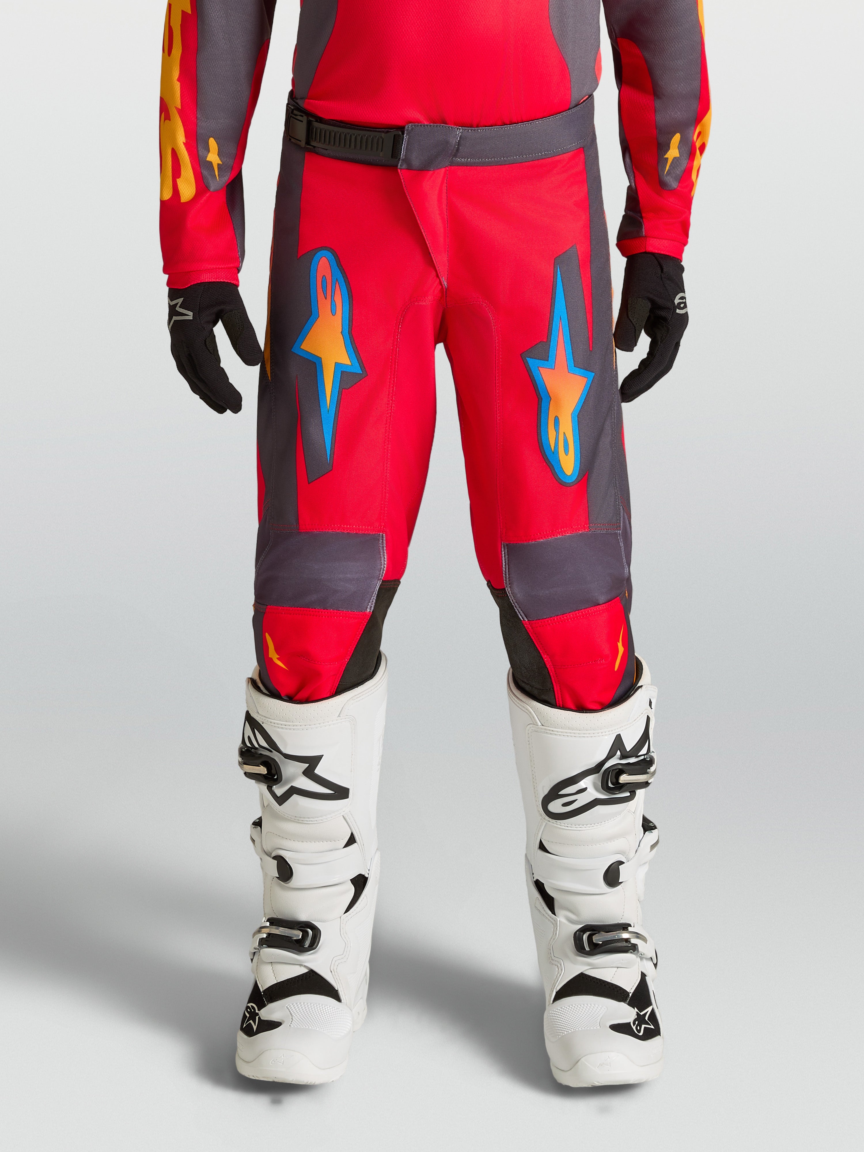 Alpinestars Youth Fluid Hunt Pants, red and gray motocross pants for off-road riding with ergonomic polyfabric design.