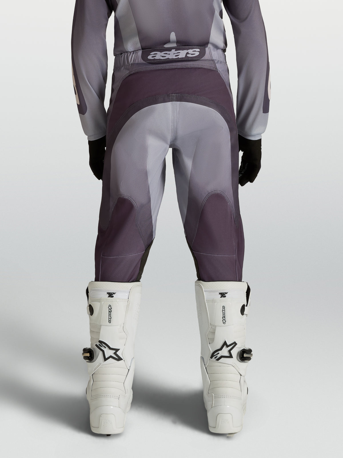 Alpinestars Youth Fluid Amber Motocross Pants in gray and sand with reinforced seat and ergonomic stretch panels.