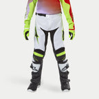 Alpinestars Youth 2024 Racer Lucent Pants, Motocross Pants, White with Neon Yellow and Black accents, worn with coordinating neon gloves and black boots, featuring ergonomic pre-curved legs and Alpinestars logos, high-performance gear for off-road racing