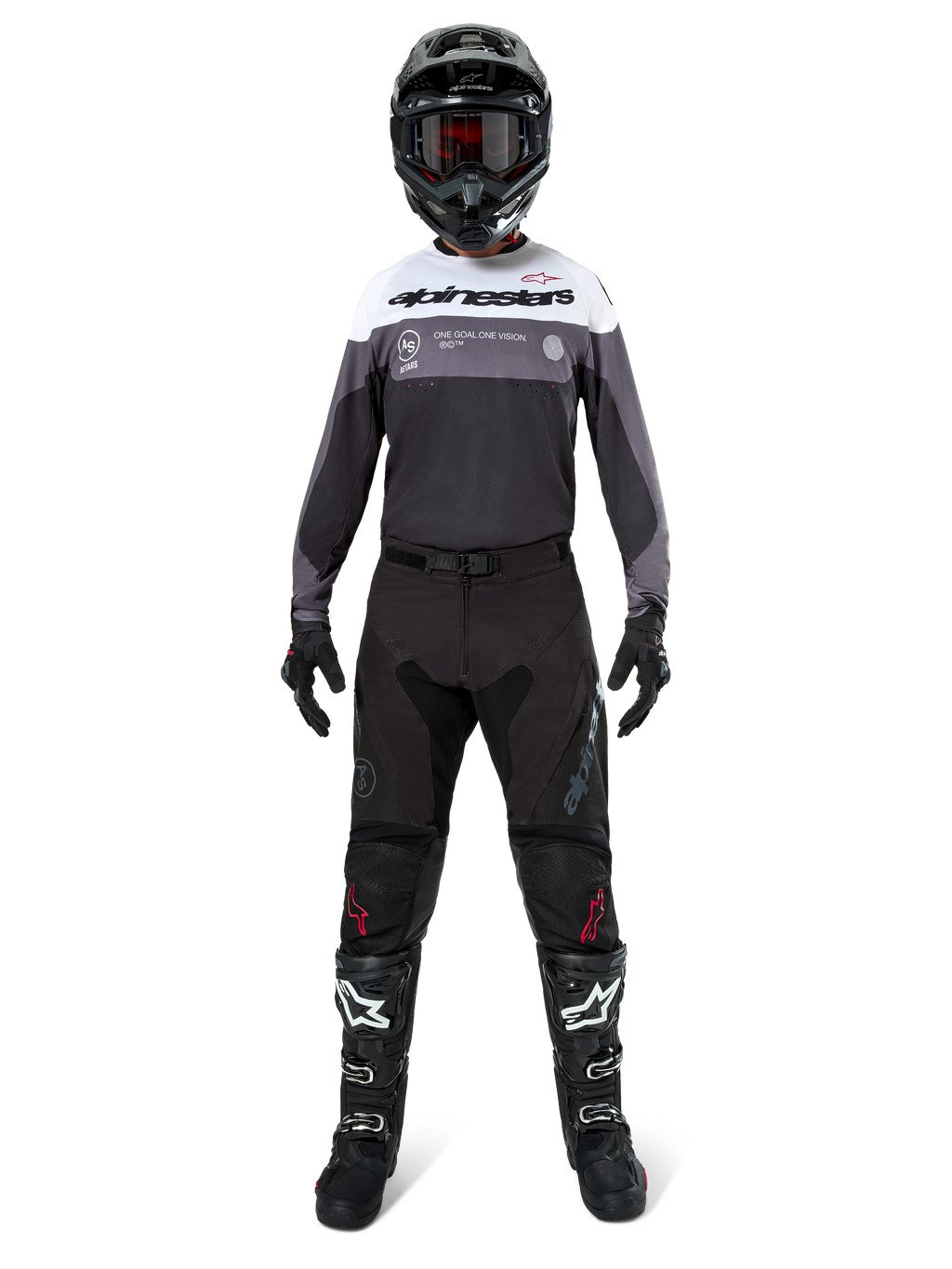 Motocross-kører iført komplet racerudstyr, Pro-Dura Jersey i Black Magnet White med hvidt øvre brystparti og grå detaljer, kombineret med sorte bukser, sort hjelm med mørke goggles, hvid-sorte støvler og sorte handsker, koordineret outfit til enduro- og terrænkørsel