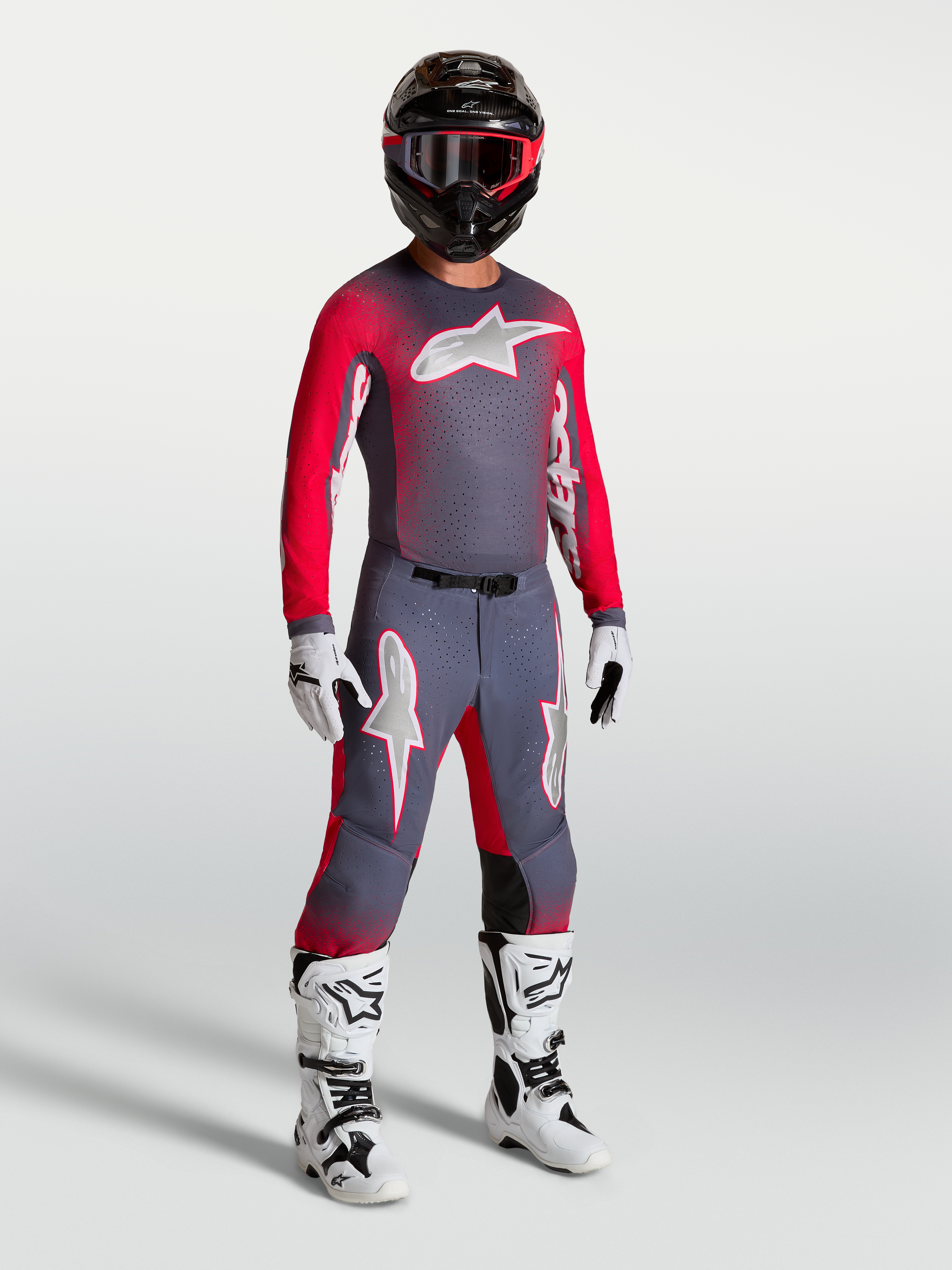 Alpinestars Supertech Hiten AFD Jersey, on-model motocross gear in graystone and red fluo, featuring a lightweight athletic fit and stretch mesh for professional MX performance.