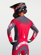 Alpinestars Supertech Hiten AFD Jersey, Motocross Racing Jersey in Graystone and Red Fluo, featuring Stretchnet back ventilation and a professional athletic fit shown on a rider.