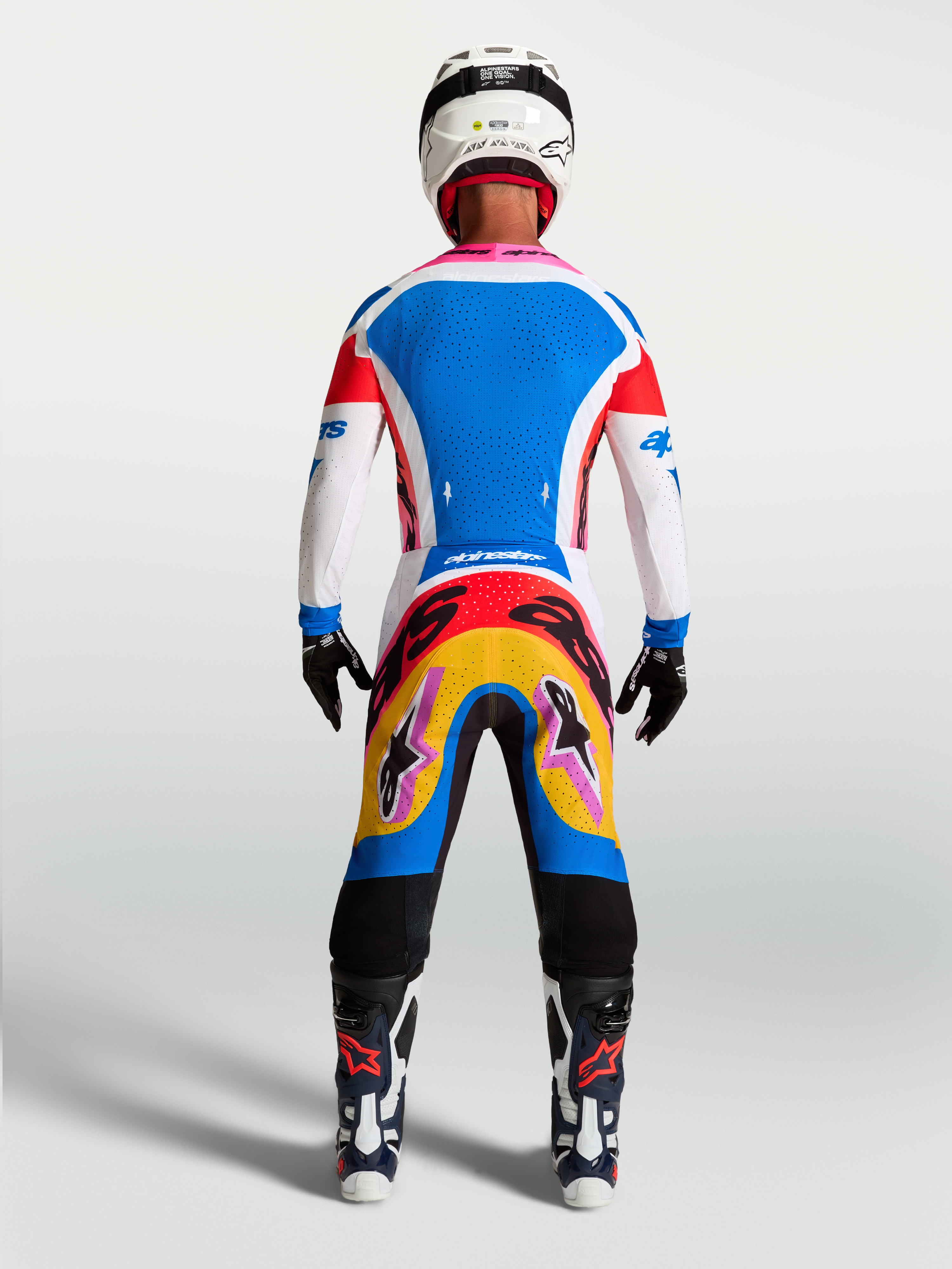 Alpinestars Supertech Dyna Jersey and Gear Set, blue and white motocross kit, rear view on-model with pink accents.