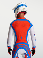 Alpinestars Supertech Vesta Jersey in red and white, featuring a ventilated mesh back for professional motocross racing.