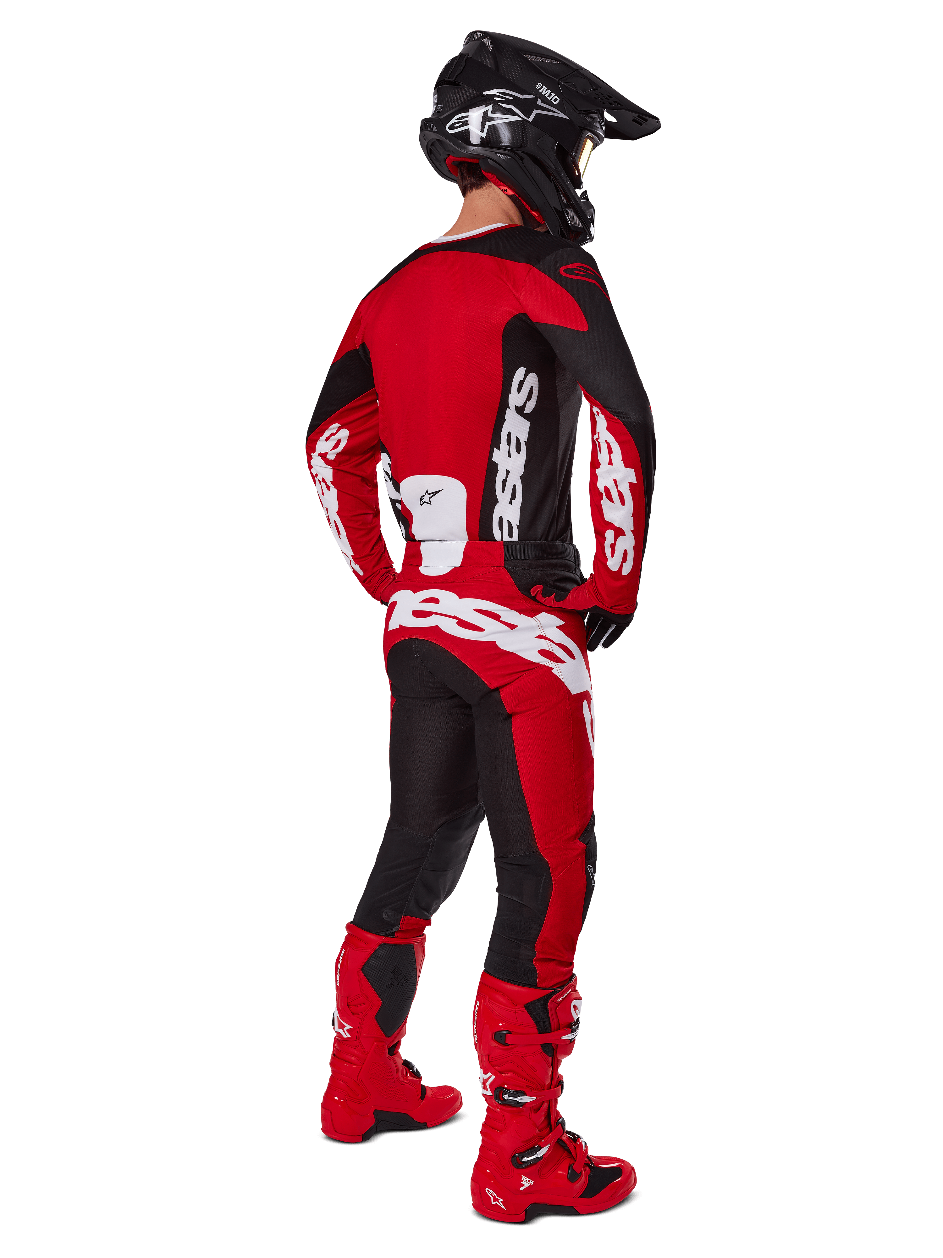 Motocross rider from the back wearing the Alpinestars 2025 Racer Veil Jersey in Black and Bright Red, coordinated with matching red and black pants and red motocross boots, featuring large white branding, ideal for off-road performance