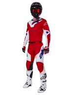 Alpinestars 2025 Racer Veil Gear Set, Motocross racing gear, Bright Red and White with Blue logo accents, worn with a black helmet, red gloves, and white boots, full protective ensemble for off-road performance
