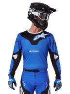 2025 Racer Veil Jersey, Motocross Racing Jersey, Blue and Black, worn with matching motocross gear including helmet and gloves, sporty design with white Alpinestars branding