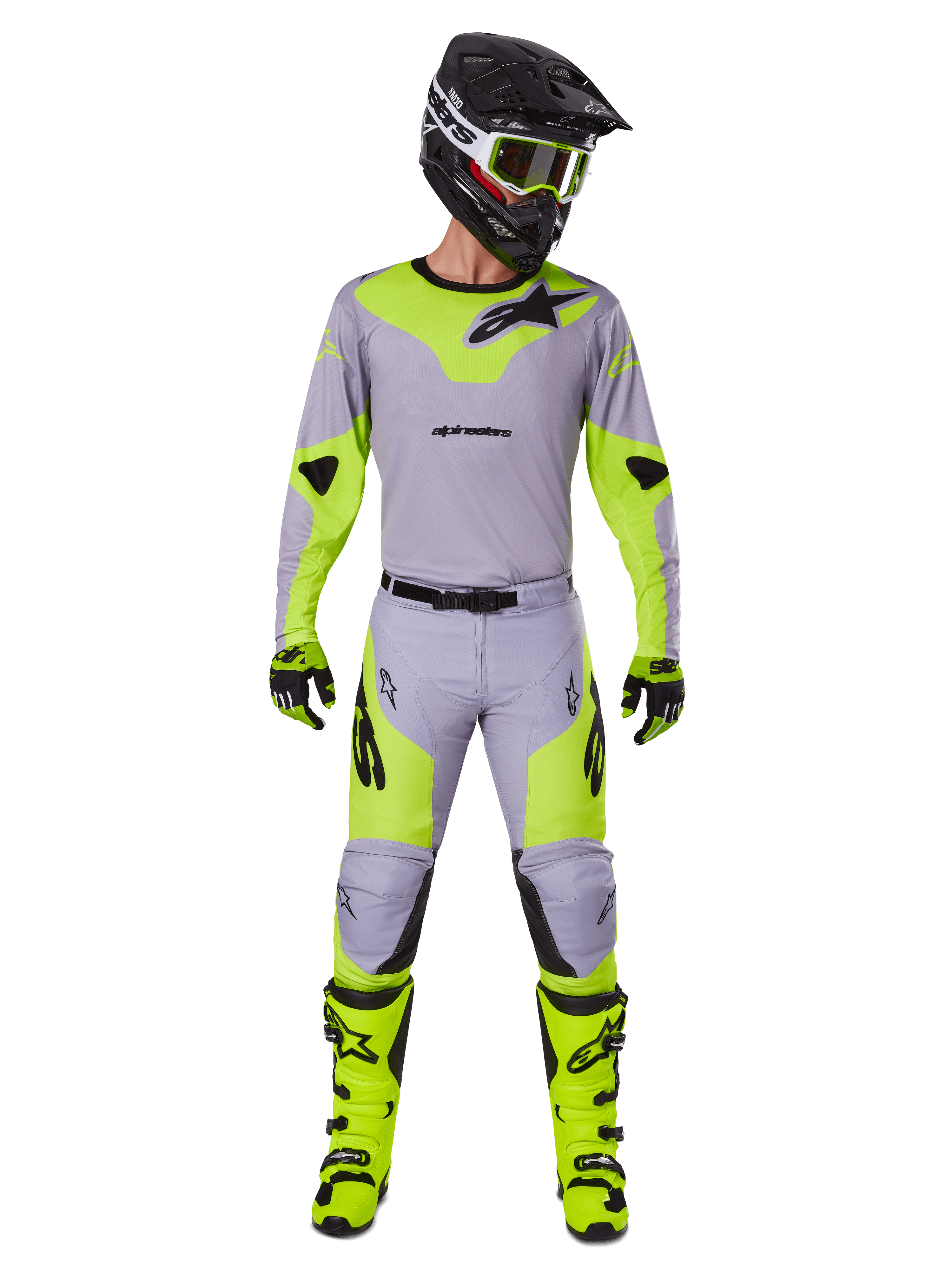 Motocross rider wearing the Alpinestars 2025 Racer Veil Gear Set in Gray and Yellow Fluo, featuring a lightweight jersey and matching pants, paired with a black helmet, fluo goggles, gloves, and high-visibility yellow boots, complete professional off-road outfit