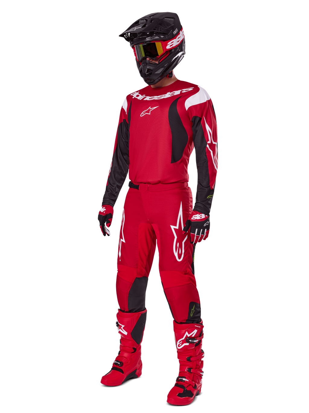 Motocross rider wearing Alpinestars 2025 Fluid Haul Gear Set, Bright Red with Black and White accents, complete outfit including jersey, pants, helmet, boots, and gloves, designed for off-road performance and protection