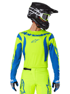 Alpinestars 2025 Fluid Haul Jersey, Motocross Jersey, Neon Yellow and Blue, featuring blue Alpinestars branding on the chest, worn with matching gear including a black helmet and blue gloves, athletic fit for off-road riding