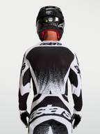 Alpinestars Techstar Swan herre-motocrosstrøje i sort og hvid, set bagfra med atletisk race fit og grafiske detaljer.