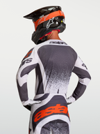 Alpinestars Techstar Swan Jersey, athletic race-fit motocross jersey in Dark Gray and White with Red highlights, shown on rider.