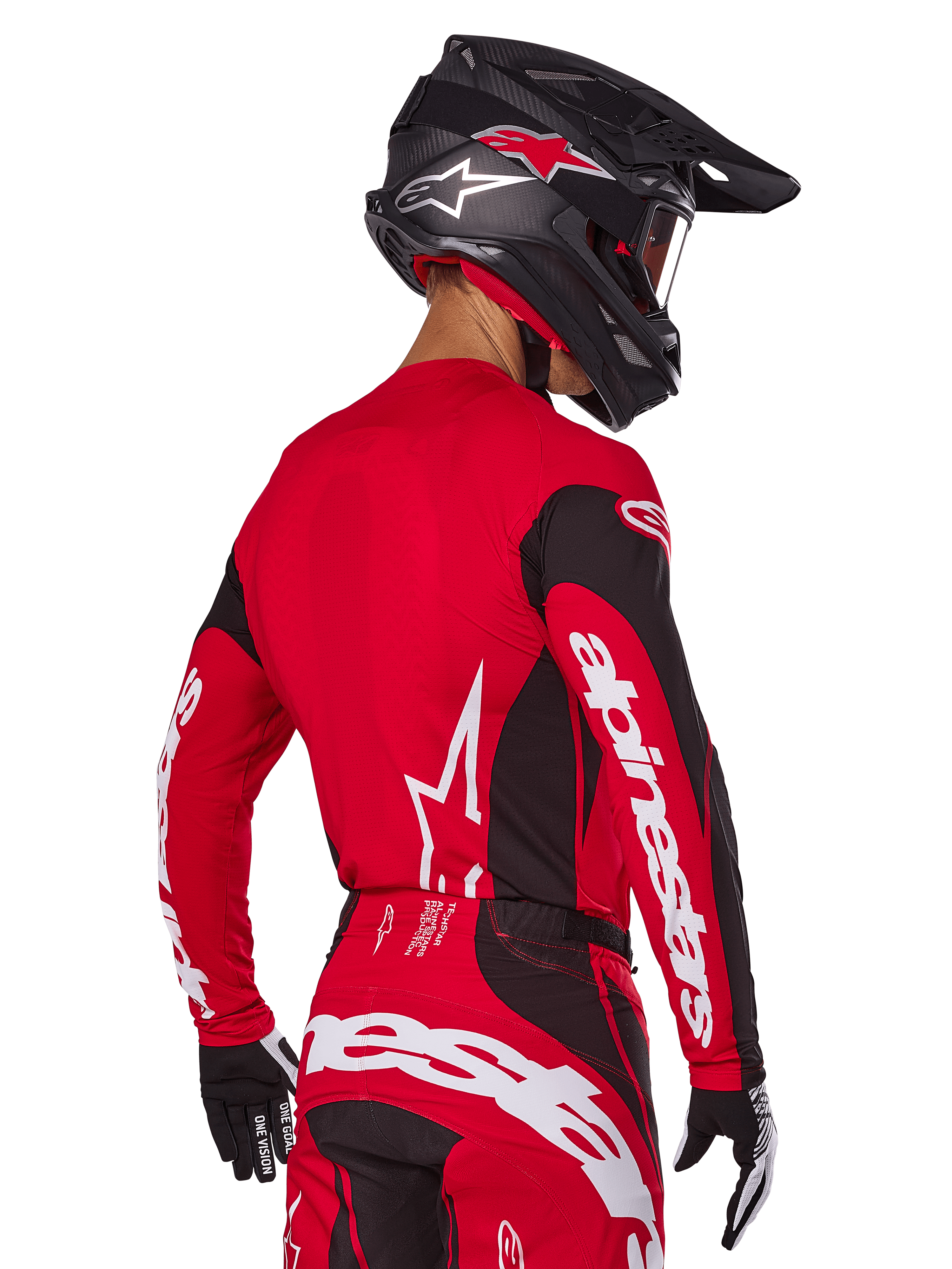 Alpinestars 2025 Techstar Dreem-udstyrssæt, motocross-kører set bagfra, rød og sort jersey med hvidt logo på ærmerne, matchende røde og sorte bukser med markant hvidt logo på bagdelen, sort carbonhjelm med røde detaljer, sort-hvide handsker, professionelt raceroutfit til terrænkørsel