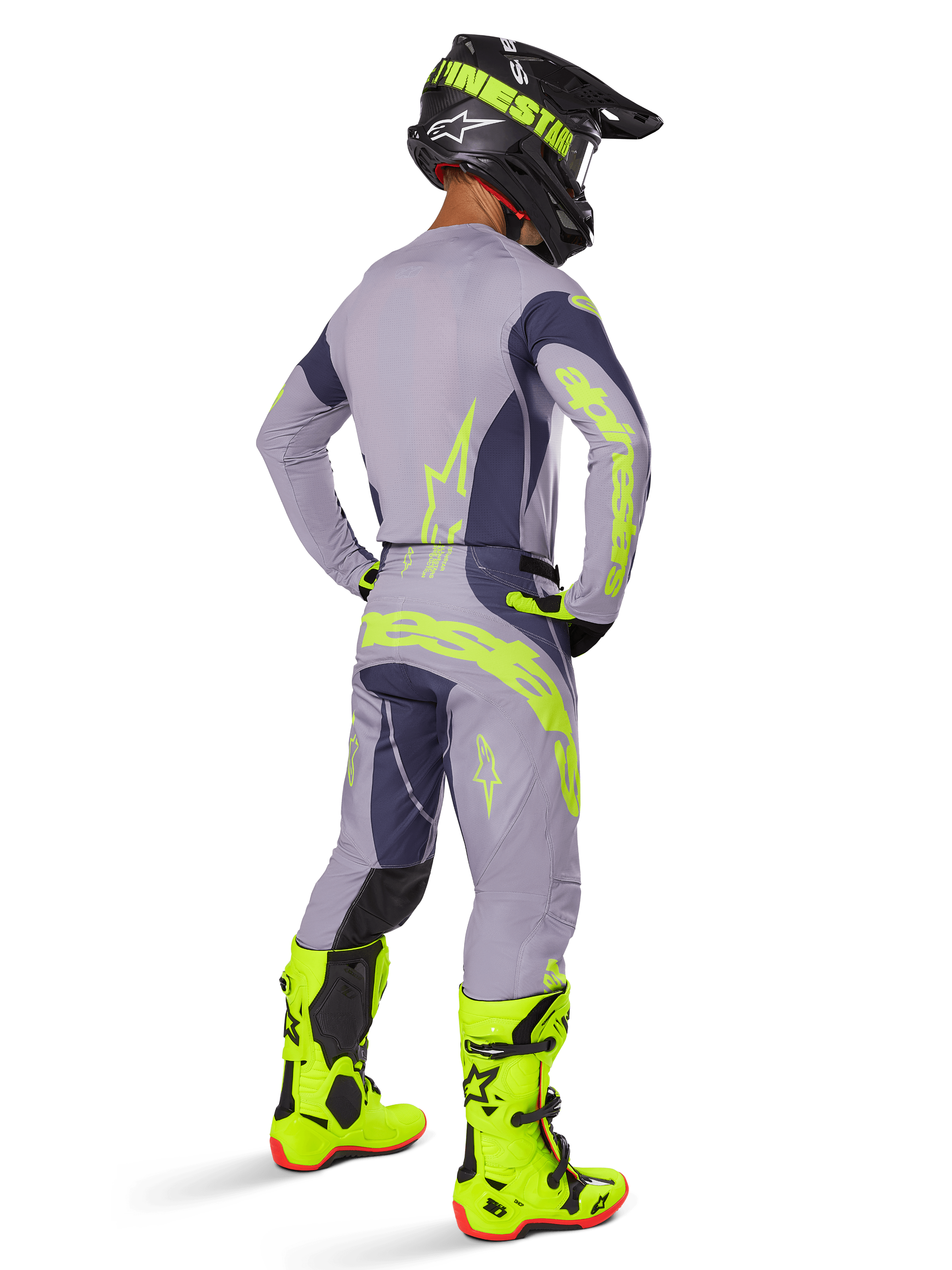 Alpinestars 2025 Techstar Dreem jersey, motocross jersey, grå og mørkegrå, båret med matchende bukser og lysende neongule støvler, set bagfra med neongul branding og atletisk pasform til off-road racing