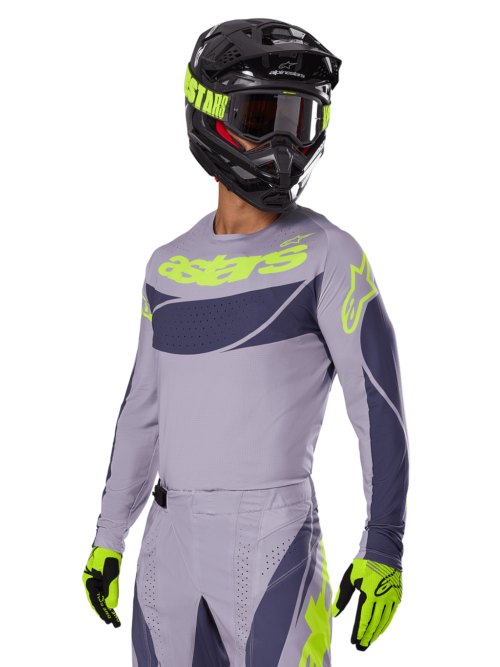 Motocross-kører iført Alpinestars 2025 Techstar Dreem Jersey i grå og mørkegrå, med et neongult 'astars' logo på brystet, kombineret med en matchende hjelm, goggles og handsker for et koordineret off-road racing-look