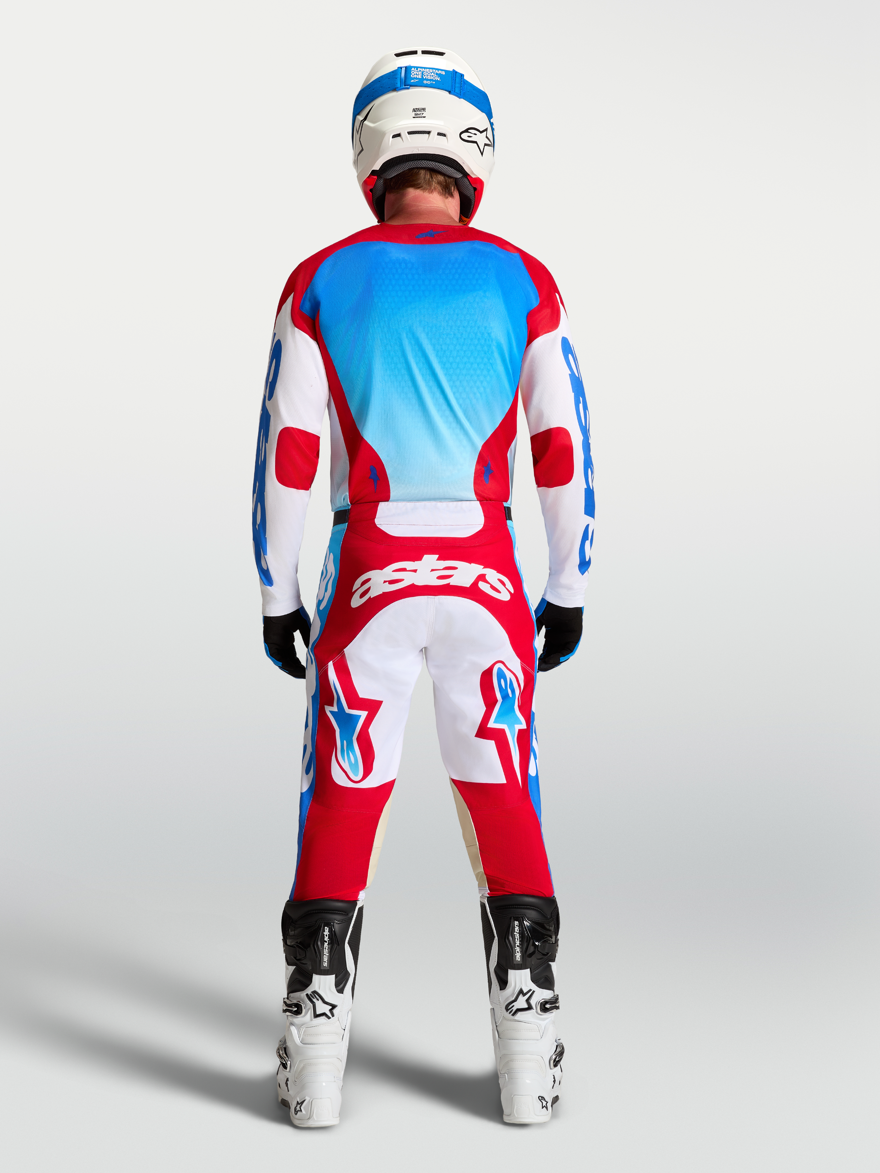 Alpinestars Racer Hunt bukser og Racer Hunt gear-sæt, motocrossudstyr til herrer, rød, hvid og blå, set bagfra på model med hjelm og støvler